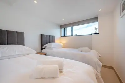 two white beds in a room with a window at 2 Bed in Polruan oc-w31943 in Fowey