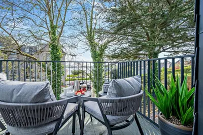 a patio with two chairs and a table on a balcony at 2 Bed in Padstow oc-h29015 in Padstow