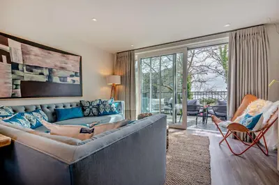 a living room with a couch and a large window at 2 Bed in Padstow oc-h29015 in Padstow