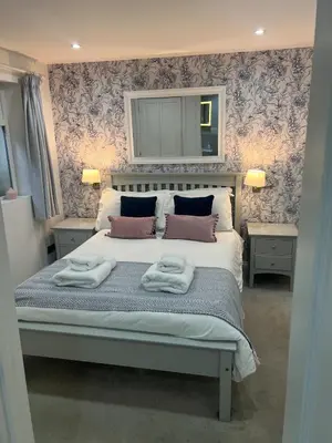 a bedroom with a bed with two towels on it at St Monica's in Fowey