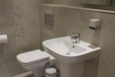 a bathroom with a white sink and a toilet at St Monica's in Fowey