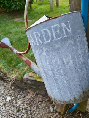 a metal bucket with the word garden written on it at Luxury Countryside Shepherds Hut with Hot Tub in Saint Mawgan