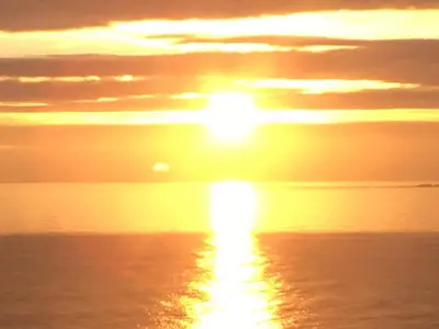 a sunset over the ocean with the sun in the sky at Ocean View at Kenwyn in Torpoint