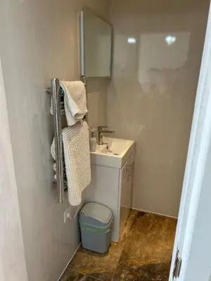 a small bathroom with a sink and a mirror at Ocean View at Kenwyn in Torpoint