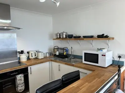a kitchen with a counter with a microwave and a sink at Ocean View at Kenwyn in Torpoint