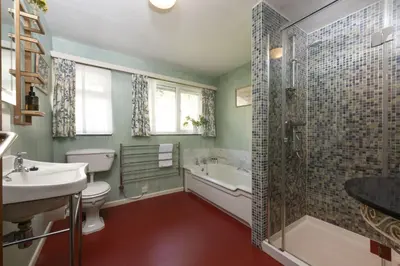 a bathroom with a toilet and a sink and a shower at Little Rabbit Hill in Polzeath