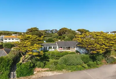 an aerial view of a house with trees and bushes at Little Rabbit Hill in Polzeath
