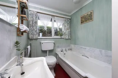 a bathroom with a tub and a toilet and a sink at Little Rabbit Hill in Polzeath