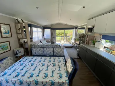 a bedroom with a bed and a couch in a room at Serenity in Saint Erth