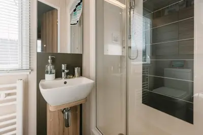 a bathroom with a sink and a shower at Serenity in Saint Erth