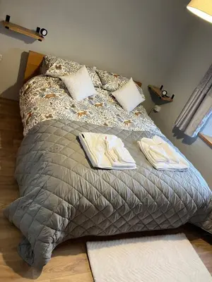 a bed with two towels and pillows on it at Knockers Retreat, St Agnes in St. Agnes