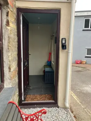 a red bench sitting in front of a door at Knockers Retreat, St Agnes in St. Agnes