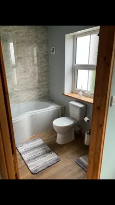 a bathroom with a toilet and a tub and a sink at Knockers Retreat, St Agnes in St. Agnes