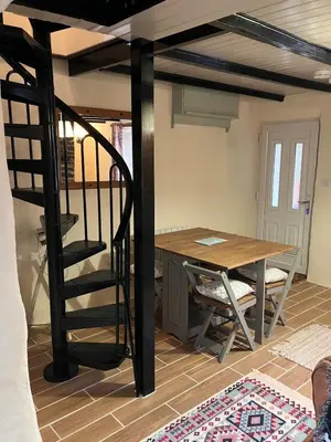 a room with a loft bed and a table at Knockers Retreat, St Agnes in St. Agnes