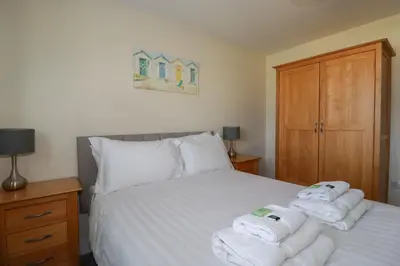 a bedroom with a bed with towels on it at Lodge 18 in Padstow