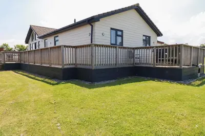 a house with a wooden fence in a yard at Lodge 18 in Padstow
