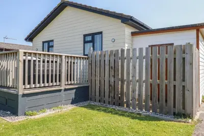 a wooden fence in front of a house at Lodge 18 in Padstow