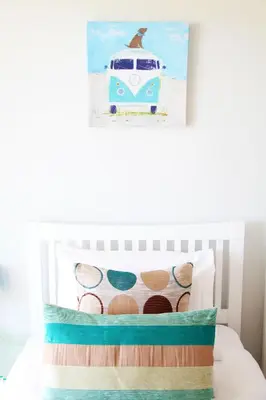 a childs bedroom with a bed with a caravan pillow at Azure 7 Apartment in Newquay