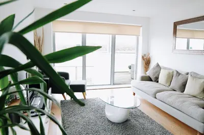 a living room with a couch and a table at Azure 7 Apartment in Newquay