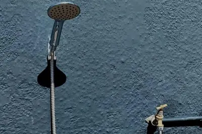 a shower in the middle of a body of water at Apartment Close To Porth Beach in Saint Columb Minor