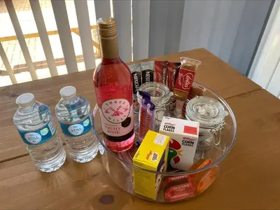 a bottle of wine and some drinks and water at Apartment Close To Porth Beach in Saint Columb Minor