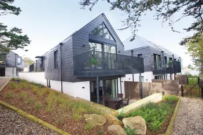 a house with a balcony on the side of it at Secluded two bedroom apartment in Padstow