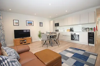 a living room with a couch and a table at Secluded two bedroom apartment in Padstow
