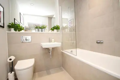 a bathroom with a toilet and a sink and a shower at Secluded two bedroom apartment in Padstow