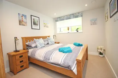 a bedroom with a bed and a window at Secluded two bedroom apartment in Padstow