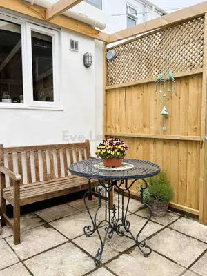 a table and a bench on a patio at Old Bookshop - Unique house in central St Ives with outdoor space in St Ives