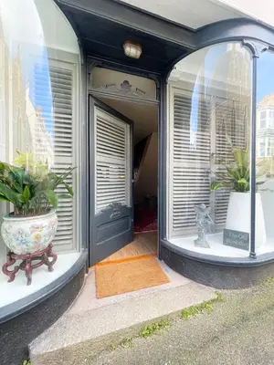 a front door of a house with two potted plants at Old Bookshop - Unique house in central St Ives with outdoor space in St Ives