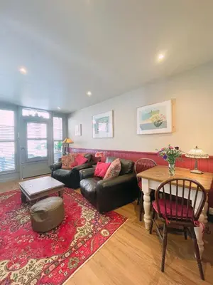 a living room with a couch and a table at Old Bookshop - Unique house in central St Ives with outdoor space in St Ives