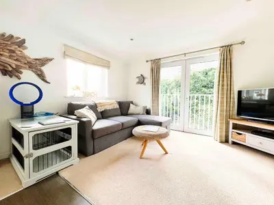 a living room with a couch and a tv at MINSTER DREAMS - A perfect seaside retreat for couples near Porthminster beach in St Ives