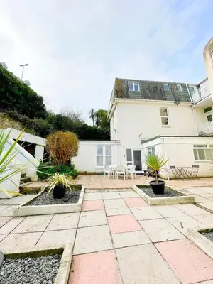 a patio with plants in front of a house at MINSTER DREAMS - A perfect seaside retreat for couples near Porthminster beach in St Ives