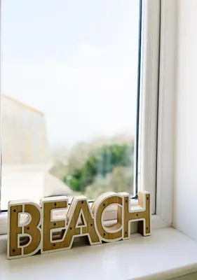 a wooden word peace sitting on a window sill at MINSTER DREAMS - A perfect seaside retreat for couples near Porthminster beach in St Ives