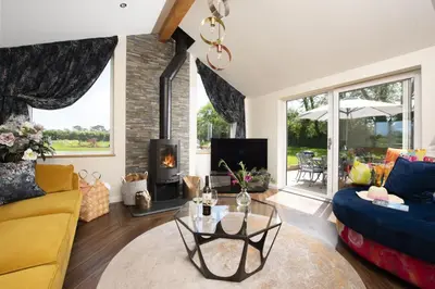 a living room with a couch and a fireplace at Highfield Barton in Camborne