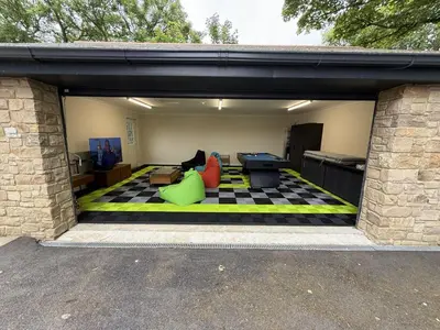 a living room with a checkered floor in a garage at Highfield Barton in Camborne