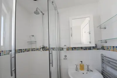 a bathroom with a shower and a sink at Cliff House in Padstow