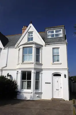 a white house with a white door and windows at Cliff House in Padstow