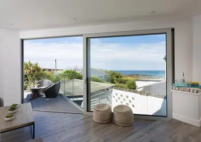 a living room with a view of the ocean at Cliff House in Padstow