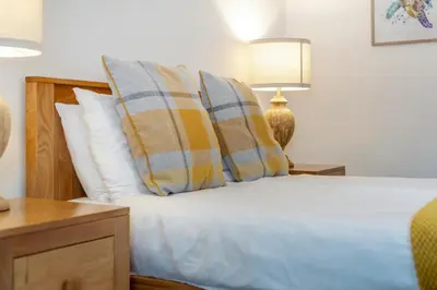 a bedroom with a bed with pillows and a lamp at 2 Bed in St. Issey oc-o27778 in Saint Issey