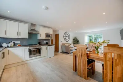 a kitchen with white cabinets and a table in a room at 2 Bed in St. Issey oc-o27778 in Saint Issey