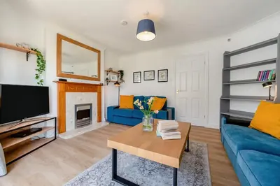 a living room with a blue couch and a tv at 3 Bed in Newquay oc-c30862 in Newquay