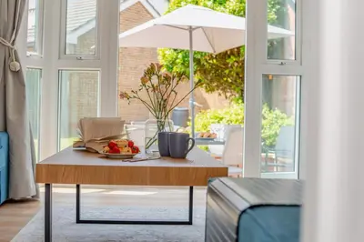 a table with a bowl of fruit and an umbrella at 3 Bed in Newquay oc-c30862 in Newquay