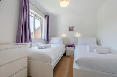 two beds in a white room with a window at 3 Bed in Newquay oc-c30862 in Newquay