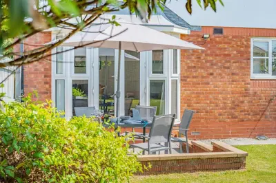 a patio with a table and chairs and an umbrella at 3 Bed in Newquay oc-c30862 in Newquay