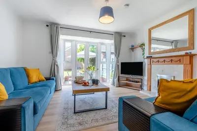a living room with a blue couch and a tv at 3 Bed in Newquay oc-c30862 in Newquay