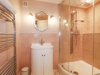 a bathroom with a sink and a shower at Rose's Stable in Truro