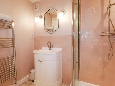 a bathroom with a sink and a shower at Rose's Stable in Truro