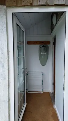 an open door to a room with a window at Menadue Cottage, Trenale Lane, Tintagel, Cornwall in Treknow